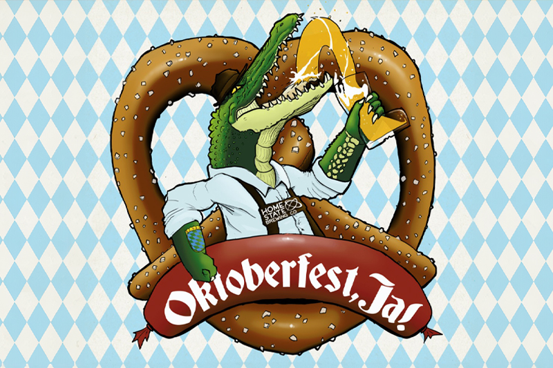 Promotional image for "Oktoberfest, Ja!" featuring a fun and whimsical illustration of an alligator dressed in traditional Bavarian attire. The alligator is holding a beer stein in one hand and biting into a large pretzel, which forms the background of the design. A red banner with the text "Oktoberfest, Ja!" is displayed at the bottom. The background features a blue and white diamond pattern, reminiscent of traditional Bavarian designs.