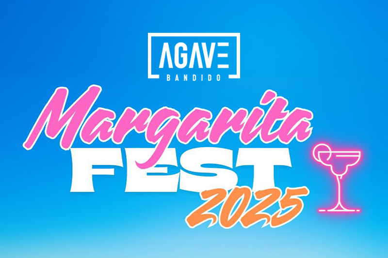 The image features a bright blue sky as the background with bold, colorful text announcing “Margarita Fest 2025.” The word “Margarita” is styled in a fun, cursive pink font. “FEST” is written in large, bold, white block letters underneath, and “2025” appears in an orange hand-painted script overlapping the bottom right. A neon-style pink margarita glass icon sits to the far right. Above the main event title is the Agave Bandido logo in white with a bold border.